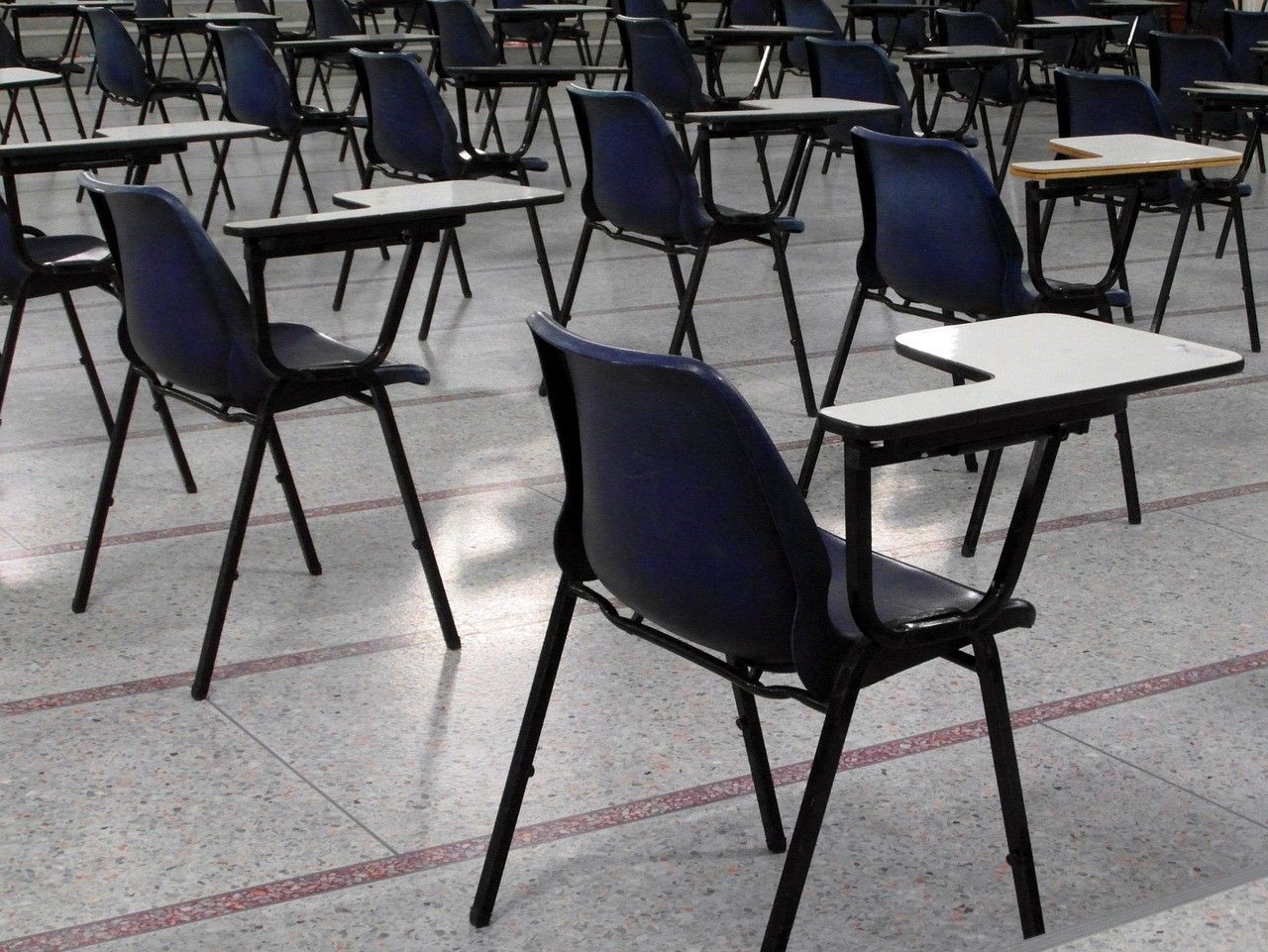 A set of empty chairs in a school room.